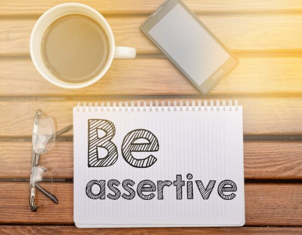 Notebook,On,Table,With,Text,About,Soft,Competence:,Be,Assertive