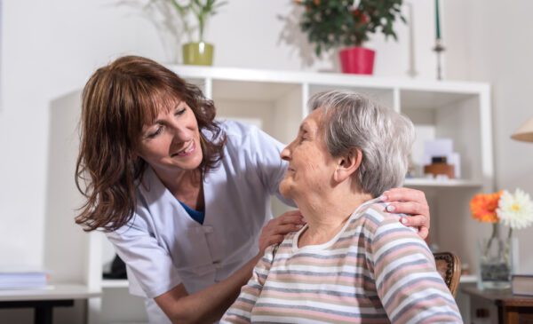 Nurse,With,Her,Hands,On,The,Shoulder,Of,A,Senior