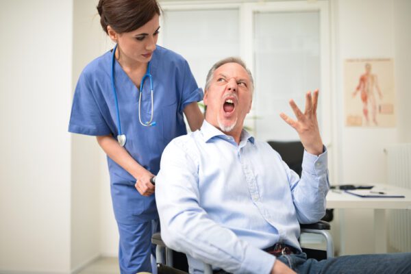 Portrait,Of,A,Disabled,Patient,Screaming,To,A,Nurse