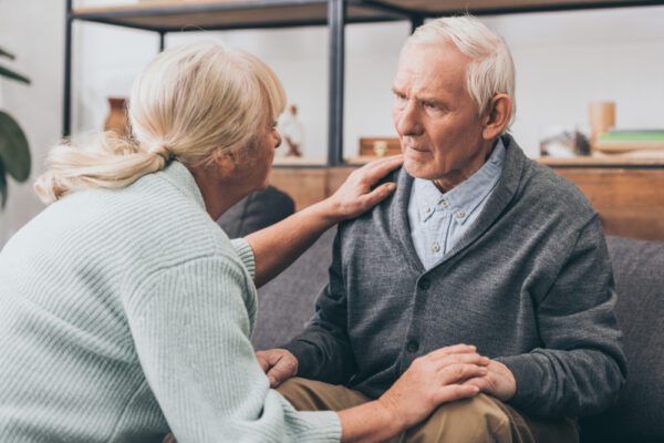 Retired,Couple,Holding,Hands,And,Looking,At,Each,Other,At