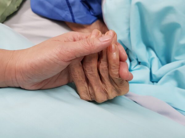 Holding,Grandmother’s,Hand,In,The,Nursing,Care.,Showing,All,Love,