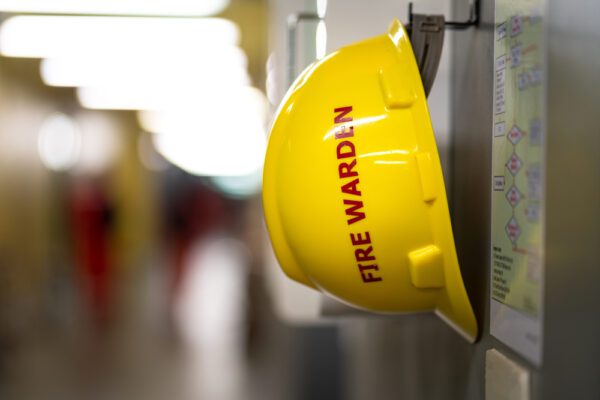 A,Yellow,Safety,Helmet,For,”fire,Warden”,Is,Hanging,On