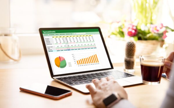 Woman,Working,With,Spreadsheets,On,Laptop,Computer