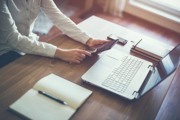 Business,Woman,Hand,Working,Laptop,Computer,On,Wooden,Desk.